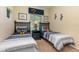 Charming bedroom featuring twin beds, neutral walls, and a window with bright natural light at 7654 Comrow St # 104, Kissimmee, FL 34747