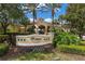 Elegant clubhouse entrance featuring manicured gardens and the Windsor Hills sign at 7654 Comrow St # 104, Kissimmee, FL 34747