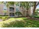 Beautiful condo exterior view showing manicured lawn and screened balcony at 7654 Comrow St # 104, Kissimmee, FL 34747