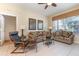 Inviting living room features tile flooring, comfy couches and neutral paint at 7654 Comrow St # 104, Kissimmee, FL 34747