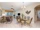 Bright living room with tile floors, stylish dining table, and lots of natural light at 7654 Comrow St # 104, Kissimmee, FL 34747
