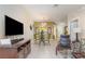 Open-concept living area with tile floors, a dining table, and contemporary décor at 7654 Comrow St # 104, Kissimmee, FL 34747