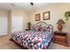 Spacious main bedroom features a large bed, two side tables, and neutral colored walls at 7654 Comrow St # 104, Kissimmee, FL 34747
