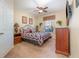 Main bedroom with large bed, side tables, ceiling fan, window, and plenty of space at 7654 Comrow St # 104, Kissimmee, FL 34747