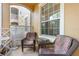 Inviting patio with comfortable wicker chairs, perfect for enjoying the outdoors at 7654 Comrow St # 104, Kissimmee, FL 34747
