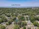 Aerial view of the house surrounded by trees, and showing Lake Monroe in the distance at 810 Catalina Dr, Sanford, FL 32771