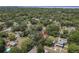 An aerial view of a home surrounded by lush trees in a quiet, residential neighborhood at 810 Catalina Dr, Sanford, FL 32771