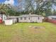 Large backyard featuring a detached garage, shed, and mature trees at 810 Catalina Dr, Sanford, FL 32771