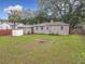 Large backyard featuring a detached garage, shed, and mature trees at 810 Catalina Dr, Sanford, FL 32771