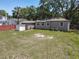 Home features a fenced backyard, a small storage shed, and ample green space, with mature landscaping at 810 Catalina Dr, Sanford, FL 32771