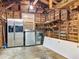 Spacious garage with exposed beams, stainless steel refrigerator, washer, and dryer at 810 Catalina Dr, Sanford, FL 32771