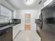 Modern kitchen features black appliances, white cabinetry, and stone backsplash at 810 Catalina Dr, Sanford, FL 32771