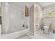 Clean bathroom with a white tub, tile flooring, and neutral-toned walls, offering a serene and minimalist space at 8800 Torey Pines Ter, Orlando, FL 32819