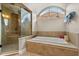 Relaxing bathroom features a garden tub, large window and separate shower at 8800 Torey Pines Ter, Orlando, FL 32819