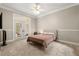 Comfortable bedroom with neutral tones, carpet, and French doors leading to the outside at 8800 Torey Pines Ter, Orlando, FL 32819
