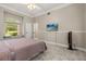 Bright bedroom featuring a window seat, TV, and a modern ceiling fan at 8800 Torey Pines Ter, Orlando, FL 32819
