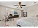 Bright bedroom with large windows and ceiling fan, providing a comfortable and airy feel at 8800 Torey Pines Ter, Orlando, FL 32819