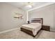 Comfortable bedroom features a ceiling fan and a window for natural light at 8800 Torey Pines Ter, Orlando, FL 32819