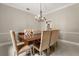 Chic dining area featuring stylish furniture, a modern chandelier and plenty of space for Gathering and friends at 8800 Torey Pines Ter, Orlando, FL 32819