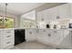 Well-lit kitchen featuring white cabinets and granite countertops, offering a blend of style and functionality at 8800 Torey Pines Ter, Orlando, FL 32819