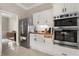 Updated kitchen with stainless steel appliances, wood countertop, and bright lighting at 8800 Torey Pines Ter, Orlando, FL 32819