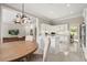 Bright kitchen features white cabinets, stainless steel appliances, and an adjacent eat-in area with a modern light fixture at 8800 Torey Pines Ter, Orlando, FL 32819