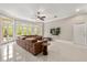 Bright living room with large windows offers ample natural light and stunning views of the lush landscape at 8800 Torey Pines Ter, Orlando, FL 32819