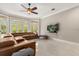 Spacious living room with large windows and modern furniture, perfect for relaxing and entertaining guests at 8800 Torey Pines Ter, Orlando, FL 32819