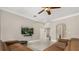 Cozy living room with a sleek ceiling fan, perfect for relaxing and watching your favorite shows at 8800 Torey Pines Ter, Orlando, FL 32819