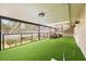 Expansive covered patio with turf, offering a relaxing outdoor space and screened enclosure at 8800 Torey Pines Ter, Orlando, FL 32819