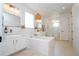Bright, modern bathroom features double vanities, a soaking tub, and glass enclosed walk-in shower at 9224 Legado Dr, Windermere, FL 34786