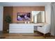 Bedroom featuring a modern vanity with a lighted mirror and wood accent wall at 9224 Legado Dr, Windermere, FL 34786