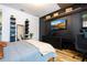 Modern bedroom featuring a sleek black accent wall, built-in storage, and a stylish decor at 9224 Legado Dr, Windermere, FL 34786