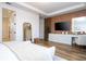 Well-appointed bedroom with wood-look flooring, a vanity, and a wood accent wall at 9224 Legado Dr, Windermere, FL 34786