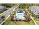 Aerial view of community pool, showcasing a pristine area with seating and lush landscaping at 9224 Legado Dr, Windermere, FL 34786
