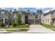 Beautiful two-story home with a two-car garage, landscaped yard, and a charming gray exterior at 9224 Legado Dr, Windermere, FL 34786