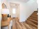 Bright foyer with hardwood floors, console table, and staircase leading to the second floor at 9224 Legado Dr, Windermere, FL 34786