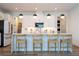 The open kitchen features a large island with seating, stylish pendant lighting, and modern appliances at 9224 Legado Dr, Windermere, FL 34786