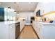 Bright, open kitchen featuring white cabinetry, stainless steel appliances, and a large center island at 9224 Legado Dr, Windermere, FL 34786