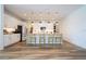 Bright kitchen features white cabinets, black appliances, wood floors, and a pendant-lit island with seating at 9224 Legado Dr, Windermere, FL 34786