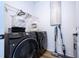 Convenient laundry area with modern washer, dryer, storage shelves and stylish laundry bags at 9224 Legado Dr, Windermere, FL 34786