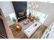 Bright, open living room features tall fireplace, modern furniture, and sliding glass doors to the patio at 9224 Legado Dr, Windermere, FL 34786