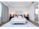 Bright and airy main bedroom featuring a tray ceiling, neutral decor and en-suite bathroom at 9224 Legado Dr, Windermere, FL 34786