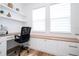 Bright home office with built-in desk, cabinets, and natural light from two windows at 9224 Legado Dr, Windermere, FL 34786