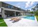 Beautiful pool and patio featuring outdoor kitchen, large patio and modern furniture at 9224 Legado Dr, Windermere, FL 34786