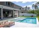 Inviting backyard pool area with patio seating, lounge chairs, and lush green landscaping at 9224 Legado Dr, Windermere, FL 34786