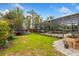 Large grassy backyard with play equipment and lush landscaping at 9880 Montclair Cir, Apopka, FL 32703