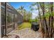 Backyard featuring a screened-in porch and outdoor grill area, perfect for entertaining at 9880 Montclair Cir, Apopka, FL 32703