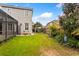 A spacious backyard featuring green lawn, play set and mature trees at 9880 Montclair Cir, Apopka, FL 32703