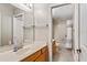Bathroom features double vanity, tile floors, a mirror, and bath/shower combo at 9880 Montclair Cir, Apopka, FL 32703